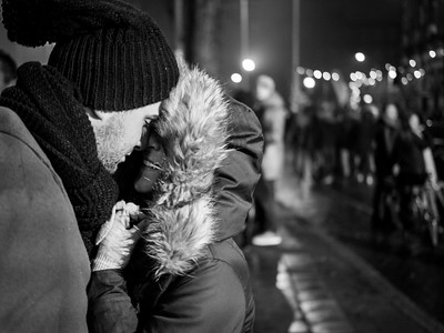 black and white image of a couple kissing