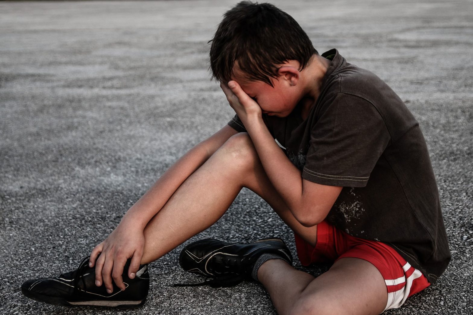 image of child with head in hands