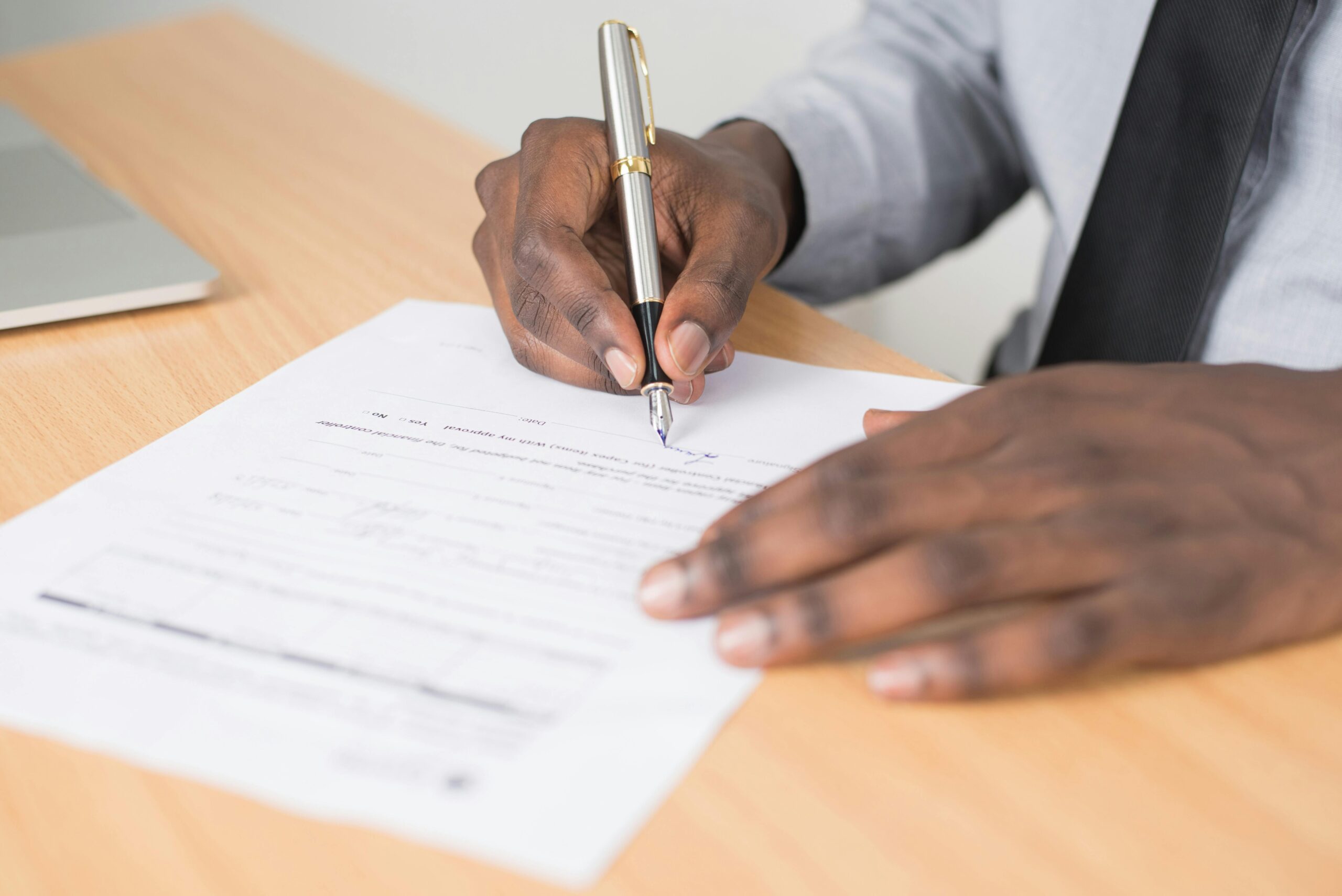an image of a man signing a bit of paper